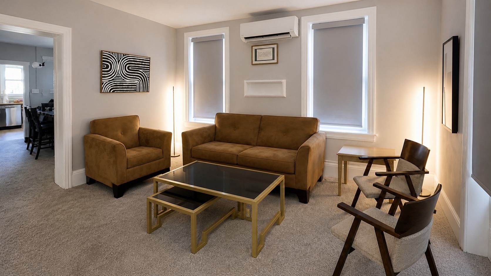 Furnished Sunlight living room with a couch, two windows, nested tables, corner lights, and additional seating